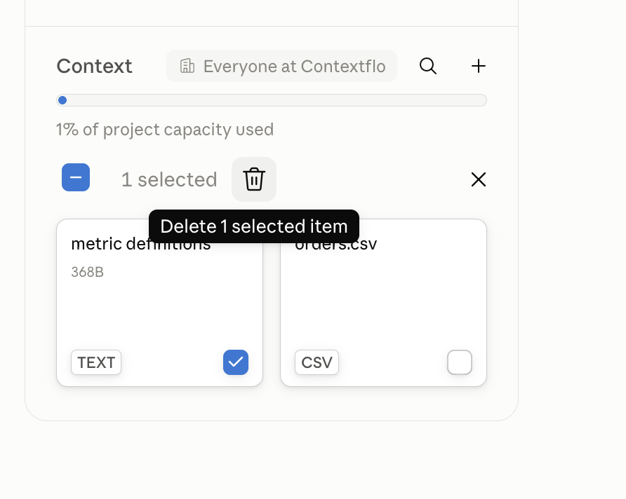 The Claude project Context panel with the metric definitions text item selected and the Delete 1 selected item action showing, next to the orders.csv file